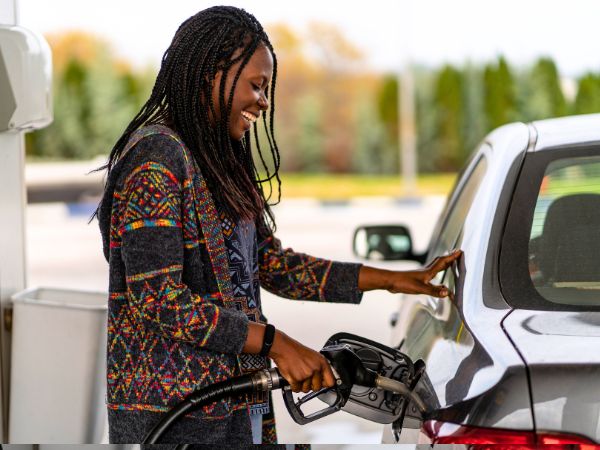 Woman Refuelling Rental Car at the Gas Station